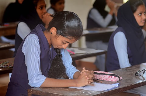A student prays before her SSLC exam at Govt High School Parambil in Kozhikode. (Photo | Manu R Mavelil, EPS)