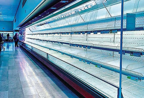 Empty aisles greet the rare shoppers at supermarkets in Milan, Italy.