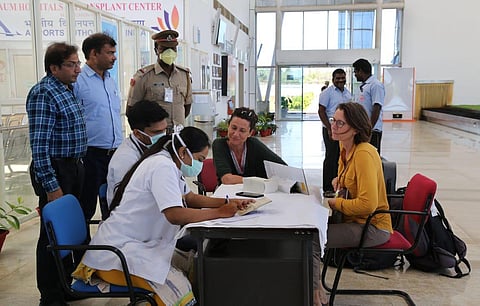 Doctors deployed at airport giving medical counselling regarding the Corono pandemic to foreign tourists entering India. (Photo | EPS/G PATTABI RAMAN)