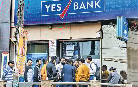 Account holders stand in a queue to withdraw money from YES Bank in New Delhi after the RBI moratorium (Photo | PTI)