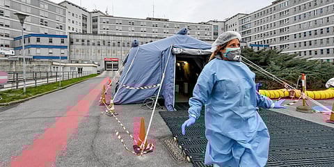 A paramedic walks out of a tent that was set up in front of the emergency ward of the Cremona hospital, northern Italy. (File photo| AP)