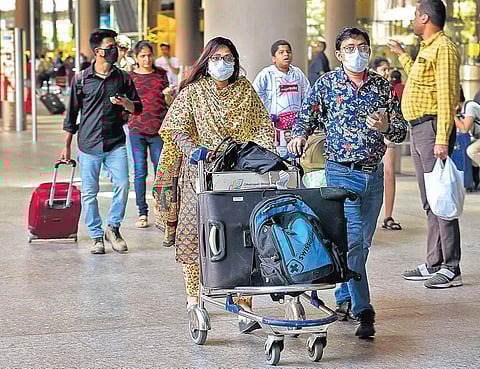 Passengers wearing protective masks as a precautionary measure against the coronavirus | PTI