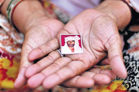 Pehlu Khan’s wife Jaiboona shows a picture of her late husband at their home in Haryana’s Jaisinghpur village. (Photo | Arun Kumar, EPS)