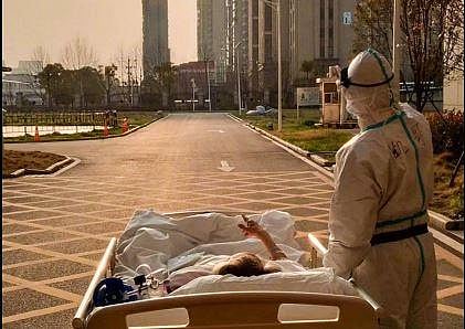 A picture of an 87-year-old CoVID-19 patient and his doctor watching the sunset outside a Wuhan hospital. (Photo | Twitter)