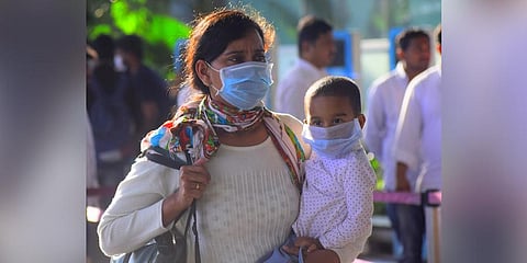 A woman and her child wear masks as a precautionary measure. (Photo | Pandarinath B, EPS)