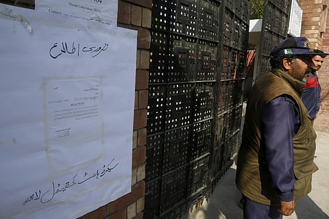 Security guards stand at the main gate of Catholic Sacred Heart Cathedral which is closed by authorities as a precautionary measure against the spread of the new coronavirus, in Lahore, Pakistan. (Photo | AP)