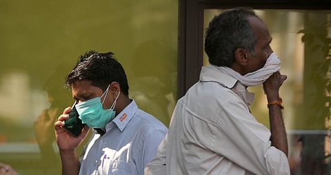 A man wearing a protective mask in the wake of novel coronavirus or COVID-19 outbreak speaks on the phone.  (Photo | Shekhar Yadav/EPS)