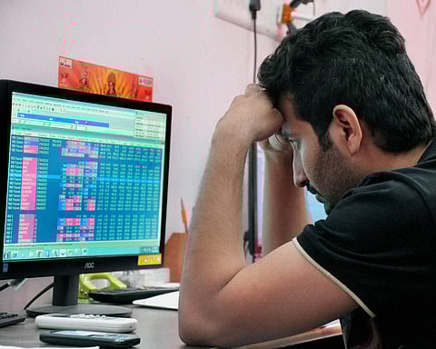 A broker reacts while watching the stocks nosedive. (Photo | PTI)