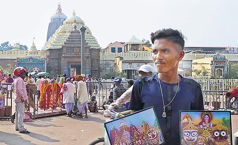 A vendor selling photographs of the Trinity in front of Srimandir  as temple administration imposed restrictions on visitors in Puri on Sunday. (Photo | Irfana, EPS)