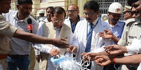 Bihar MLA distributes masks outside the assembly among the politicians and the media persons. (Photo| Ranjit K Dey, EPS)