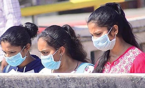 Girls take safety measures as the city goes into prevention mode after the first death owing to COVID-19 was reported in Karnataka | pandarinath B