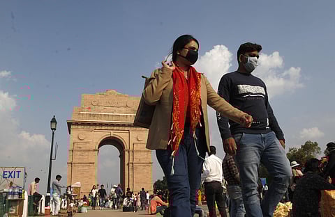 Tourists wearing masks at the India Gate in New Delhi on Sunday. (Photo | Anil Shakya, EPS)