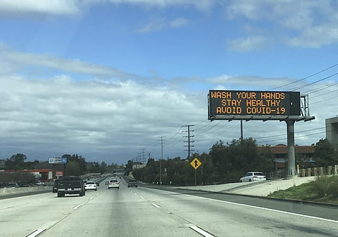 A Caltrans freeway sign reads: 'Wash your hands, Stay healthy, Avoid COVID-19' in the San Fernando Valley section of Los Angeles. (Photo | AP)