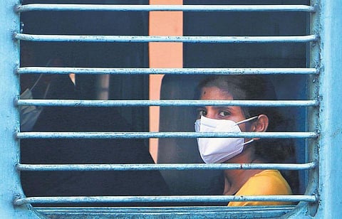 In the wake of the coronavirus outbreak, train travellers take precautionary measures such as protective masks. (Photo | EPS, TP Sooraj)