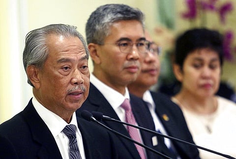 Malaysian Prime Minister Muhyiddin Yassin, left, speaks during a press conference at prime minister's office. (Photo | AP)
