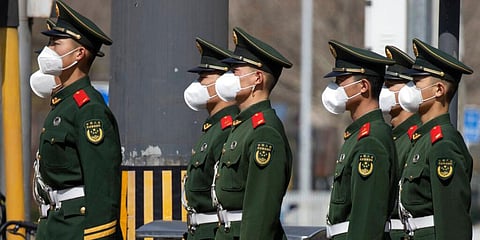 Chinese paramilitary wearing masks form up during their duty in an embassy district in Beijing. (Photo | AP)