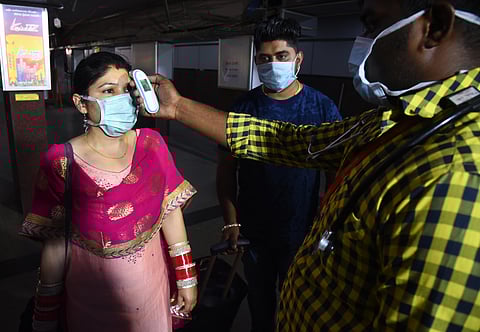 Health department screening passengers with thermal screening at the special medical help desk created at the Coimbatore Railway Junction on Monday to find symptoms of coronavirus. (Photo | A Raja Chidambaram/EPS)