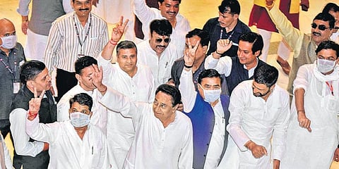 Madhya Pradesh CM Kamal Nath and Congress legislators flash the victory sign at the Vidhan Sabha on Monday. (Photo | PTI)