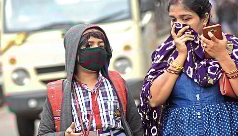A school student and her mother cover their faces for protection against coronavirus. (Photo| EPS/ Biswanath Swain)