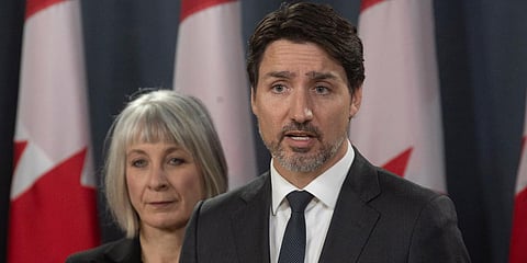Canada PM Justin Trudeau speaks during a news conference in Ottawa as Minister of Health Patty Hajdu looks on. (Photo| AP)