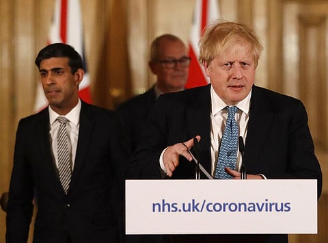 Britain's Chancellor Rishi Sunak, British Prime Minister Boris Johnson and Chief scientific officer Patrick Vallance arrive for a press briefing about the ongoing situation with the COVID-19 coronavirus outbreak, inside 10 Downing Street in London, Tuesda