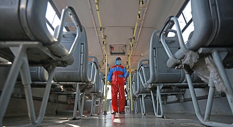 A volunteer sprays disinfectants in a DTC bus in the wake of coronavirus at Sunehri Pul bus depot,in New Delhi.(Photo | Shekhar Yadav, EPS)