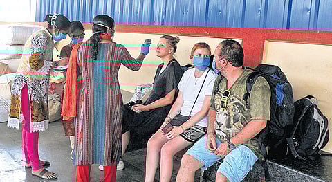 Health workers and police officials screening foreign tourists who arrived at Ernakulam Junction railway station from Thiruvananthapuram. They were shifted to a hospital after they were found to have symptoms of Covid-19 |  A Sanesh 