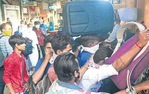 Migrant labourers going back to their native places in the wake of Covid-19 scare. Rush of such people boarding trains was seen at Kozhikode railway station on Wednesday | T P Sooraj