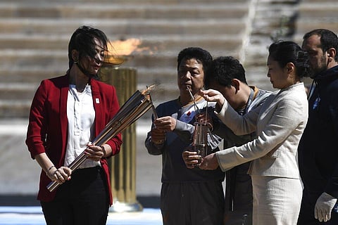 Former Japanese swimmer Imoto Naoko holds the Olympic torch during the Olympic flame handover ceremony for the 2020 Tokyo Summer Olympics, in Athens. (Photo | AP)