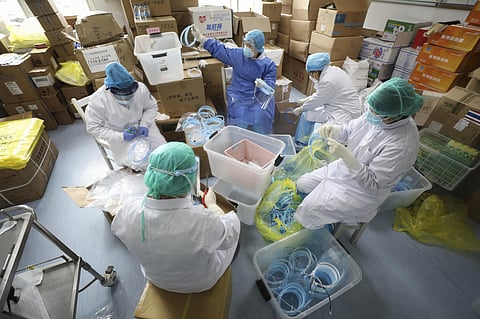 Nurses assemble plastic face shields at a hospital designated for the coronavirus patients in Wuhan in central China's Hubei province, Sunday, March 01, 2020. (Photo | AP)