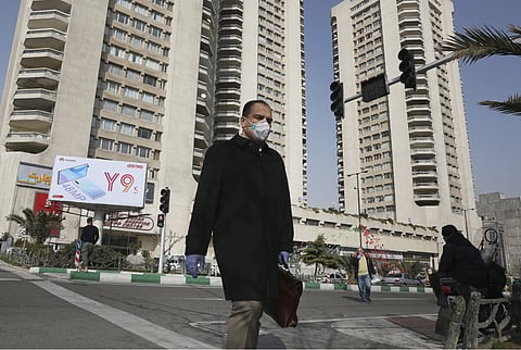 A pedestrian wearing a face mask crosses a street in northern Tehran, Iran, Sunday, March 1, 2020. (Photo | AP)