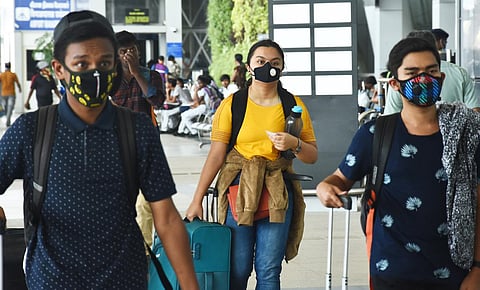 Passengers wear masks at Chennai airport on Friday.(Photo | Ashwin Prasath, EPS)