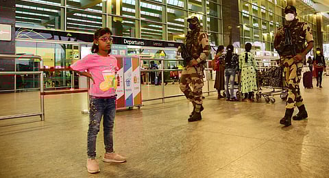 The otherwise busy KIA wears a deserted look on Tuesday as security personnel don masks as they patrol the airport | Vinod Kumar T