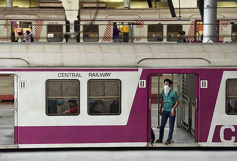 Passenger wearing a face mask as a measure to prevent coronavirus spread boards a train at CST railway station in Mumbai Friday March 20 2020. (Photo | PTI)