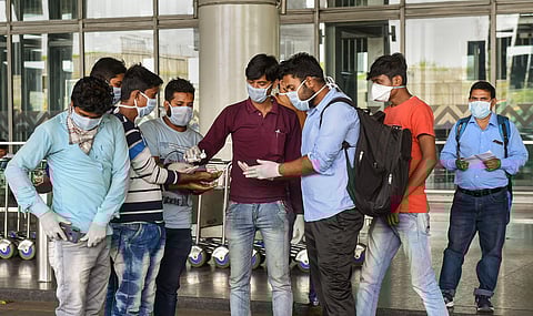 Volunteers pump sanitizer on hands of visitors and workers in the wake of deadly coronavirus at NSCBI Airport in Kolkata Thursday March 19 2020. (Photo | PTI)