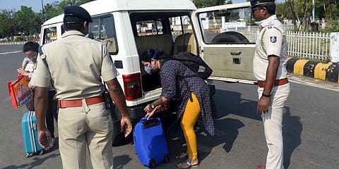 Security personnel helping passengers for a drop at Airport during Janata Curfew in Bhubaneswar on Sunday. (Photo|  Biswanath Swain, EPS)