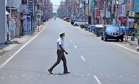 Traffic police person with a face mask seen on duty at the deserted oppanakara street in coimbatore on sunday following the janata curfew. (Photo | Raja Chidambaram, EPS)