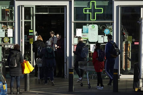 National Health Service staff show their ID at a Sainsbury's supermarket 30 minutes before other customers at the start of trading. (Photo | AP)