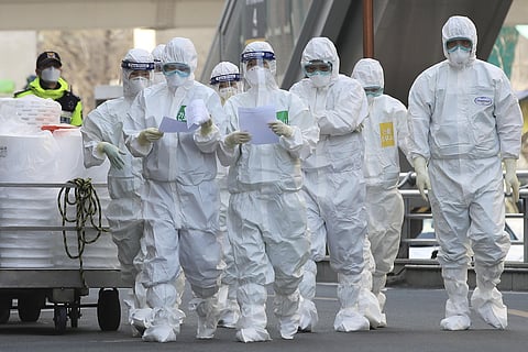Medical staff members arrive for a duty shift at Dongsan Hospital in Daegu, South Korea, Tuesday, March 24, 2020. (Photo | AP)