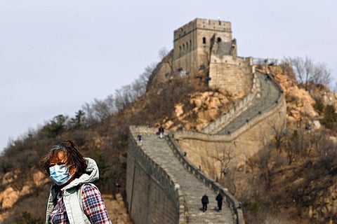 A woman wearing a protective face mask visits the Badaling Great Wall of China after it reopened in China. (Photo | AP)