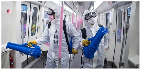 In this March 23, 2020 photo released by Xinhua News Agency, workers disinfect a subway train in preparation for the restoration of public transport in Wuhan, in central China's Hubei province. (Photo | AP)