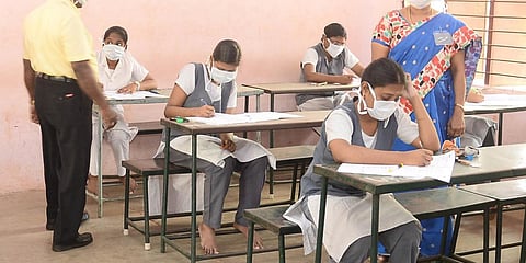 Students are seen writing the Plus one examinations wearing masks at MC School in Madurai. (Photo| EPS)