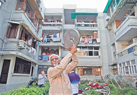 People come out to clap, clang utensils at an apartment to cheer health workers. (Photo | Anil Shakya/EPS)