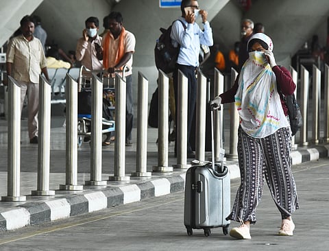 People seen with face mask waiting at Chennai Airport as many domestic flights been cancelled. (Photo | Ashwin Prasath/EPS)