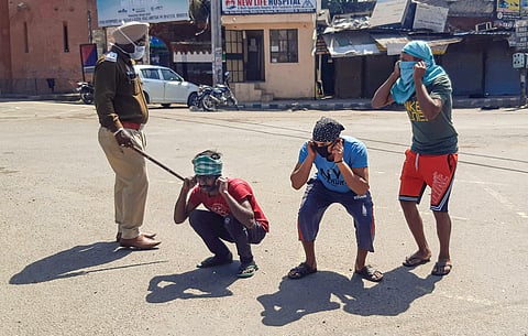 Police punish offenders for flouting the lockdown guidelines on the first day of the 21-day nationwide lockdown in the view of coronavirus pandemic. (Photo | PTI)