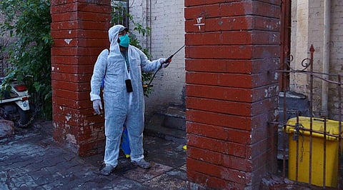 A volunteer sprays disinfectant (Photo | AP)
