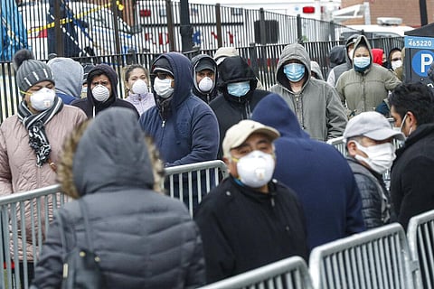 Patients wear personal protective equipment while maintaining social distancing as they wait in line for a COVID-19 test at Elmhurst Hospital Center, Wednesday, March 25, 2020, in New York. (Photo | AP)