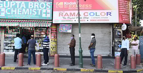 People stand in a queue outside a chemist shop while maintaining social distancing during a nationwide lockdown in the wake of coronavirus pandemic. (Photo | Parveen Negi, EPS)
