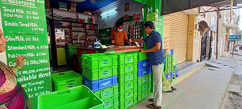 A milk vendor in Hyderabad maintains social distance with consumers by using temporary barricades at his shop due to Coronavirus outbreak. (Photo | R V K Rao, EPS)