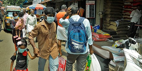 People walking the streets wearing mask as part of a precautionary measure against COVID-19 at Ernakulam market. (File Photo | Arun Angela, EPS)